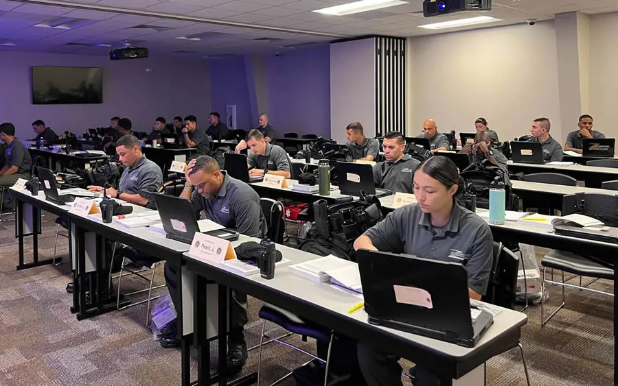 Classroom filled with cadets seated at desks during a training session.