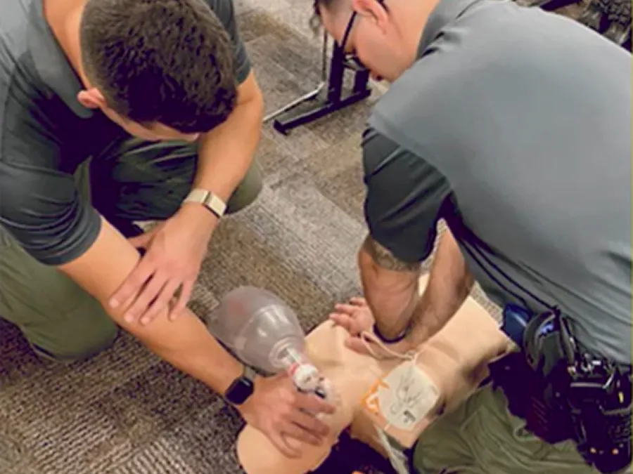 Cadets practicing CPR on a manikin