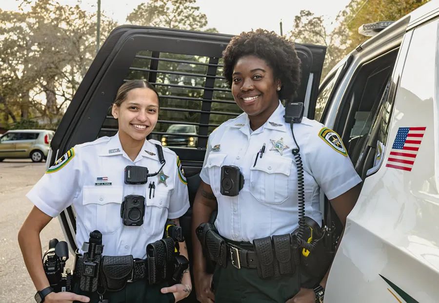 two deputies smiling on the job