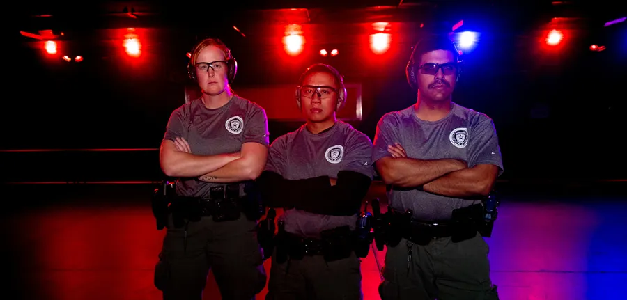 Three deputies at an indoor shooting range